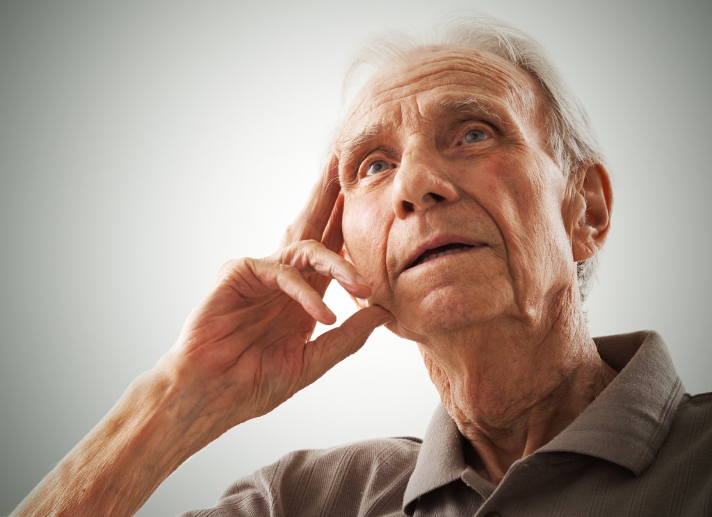 An elderly man looking confused.