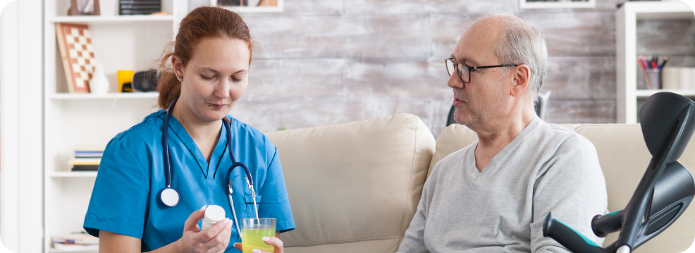 A female carer assisting a senior man.