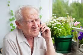 A senior man talking on the phone.